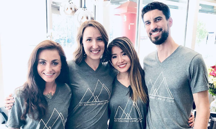 Elevate Smile Design dream team wearing matching gray t-shirts, with Drs. Mai and Perlman on the right