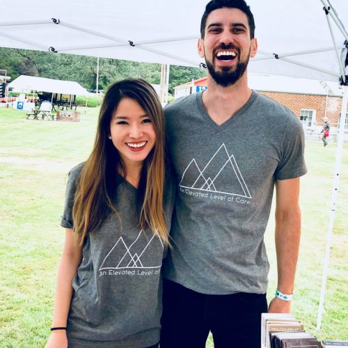 Dr. Perlman and Dr. Mai wear gray Elevate Smile Design t-shirts at the LeMay Car Show at Marymount