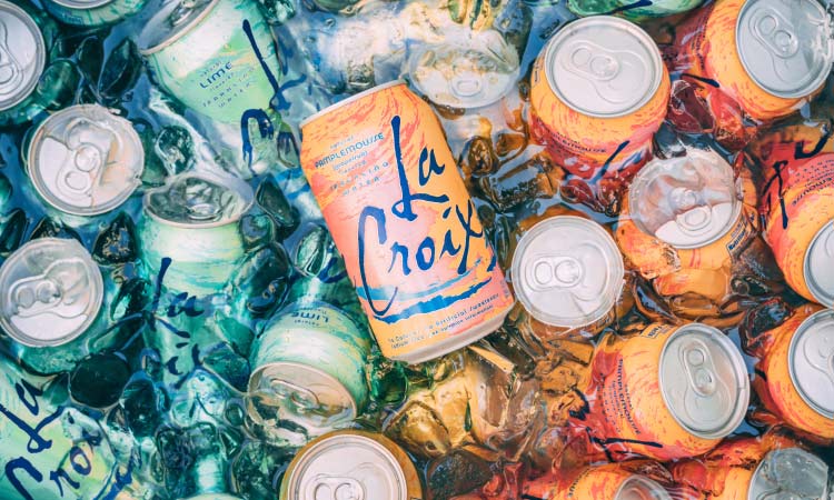 Aerial view of cans of La Croix sparkling water in a bin of melting ice water