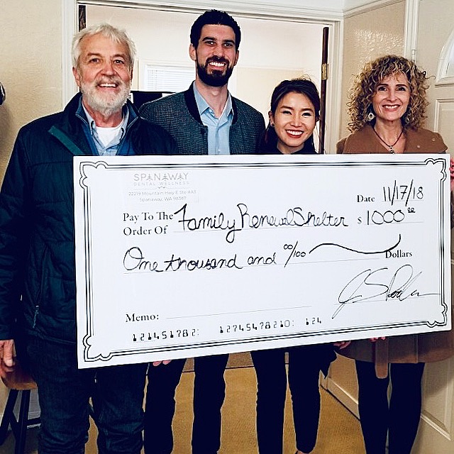 The Elevate Smile Design team hands a large check to the Tacoma’s Family Renewal Shelter
