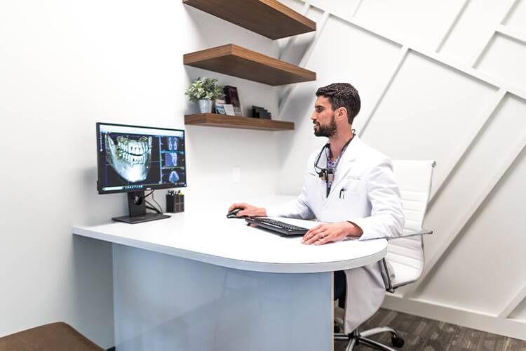 Dr Perlman looking at dental images