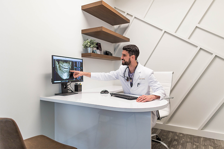 Dr Perlman pointing at a dental image