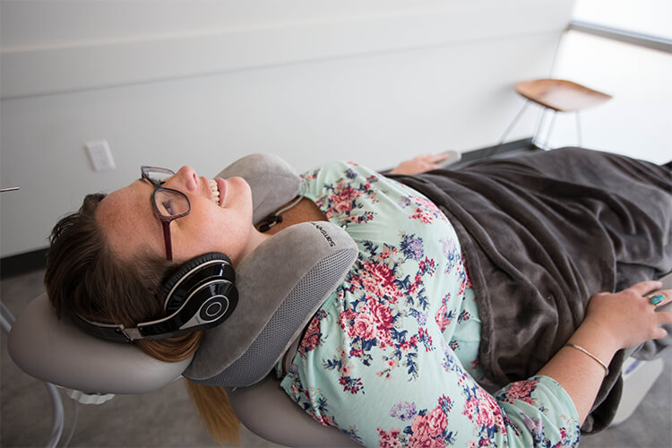 Young woman laying back in dentist chair