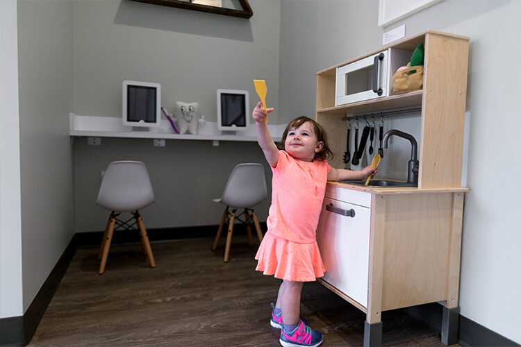 Little girl playing with toys in office