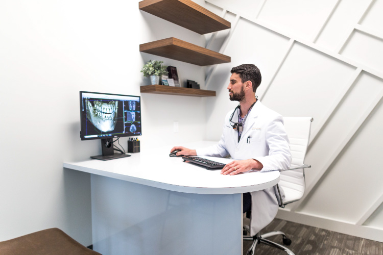 Dr. Perlman looks at a photo of a patient's mouth that is cavity-free