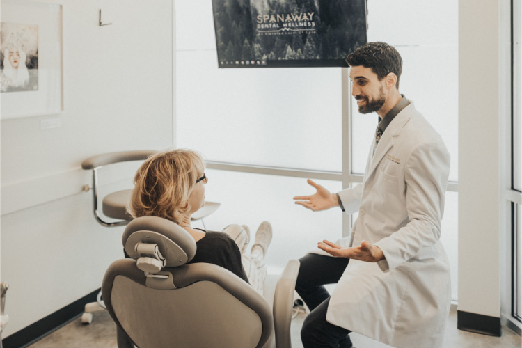 Dr. Perlman explains the root canal therapy procedure to his blonde patient