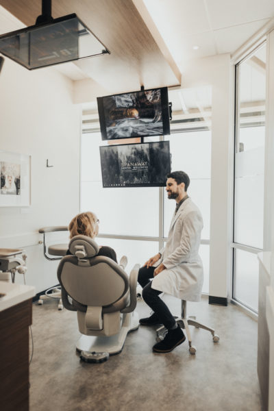 Dr. Perlman discusses with a female patient what she can expect after a dental bridge