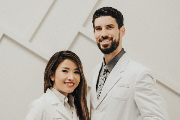 Spanaway doctors standing next to each other with big smiles as they prepare to help clients fight periodontal disease